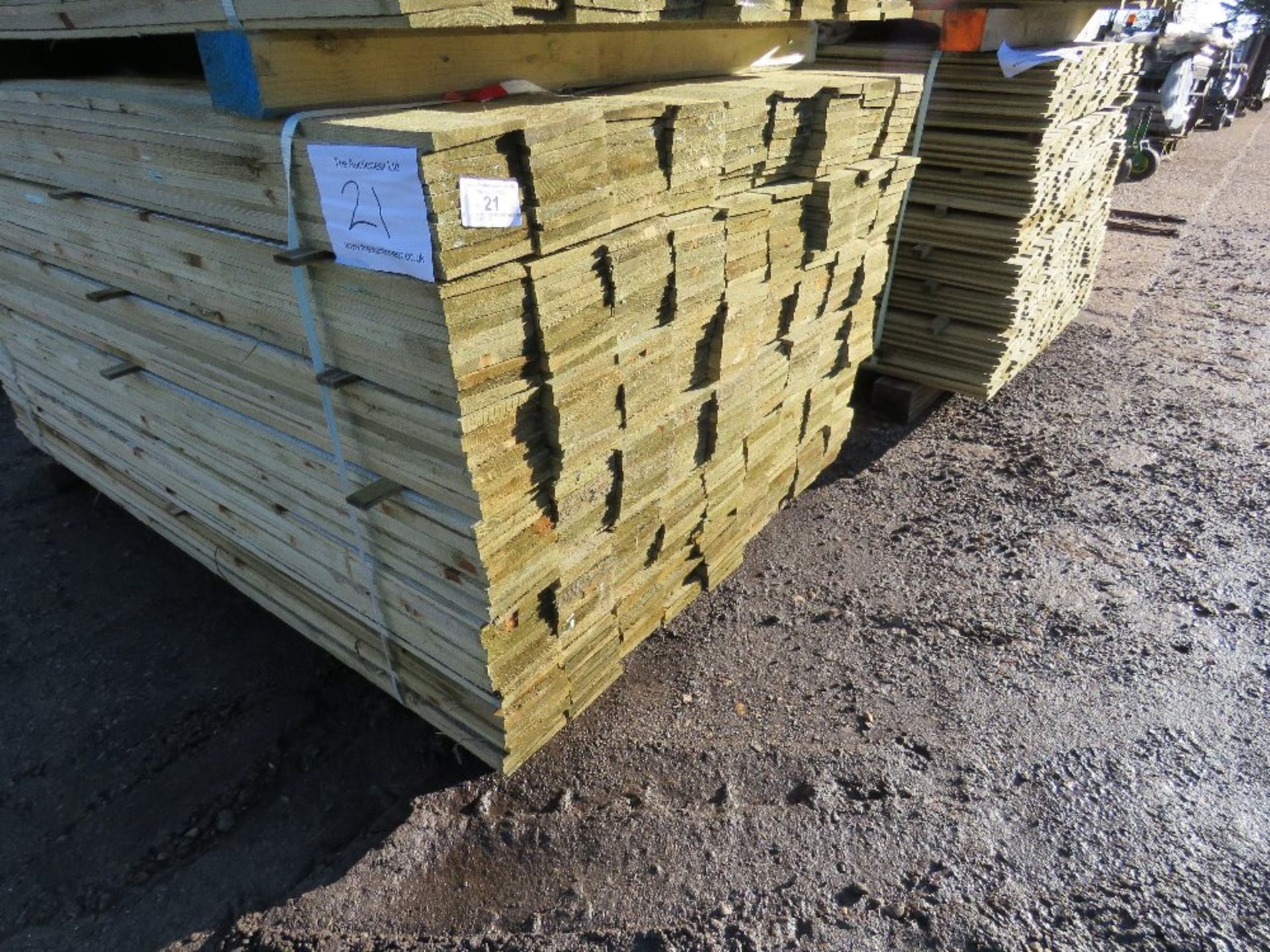 PACK OF TREATED FEATHER EDGE FENCE CLADDING BOARDS. 1.5M X 10CM APPROX.