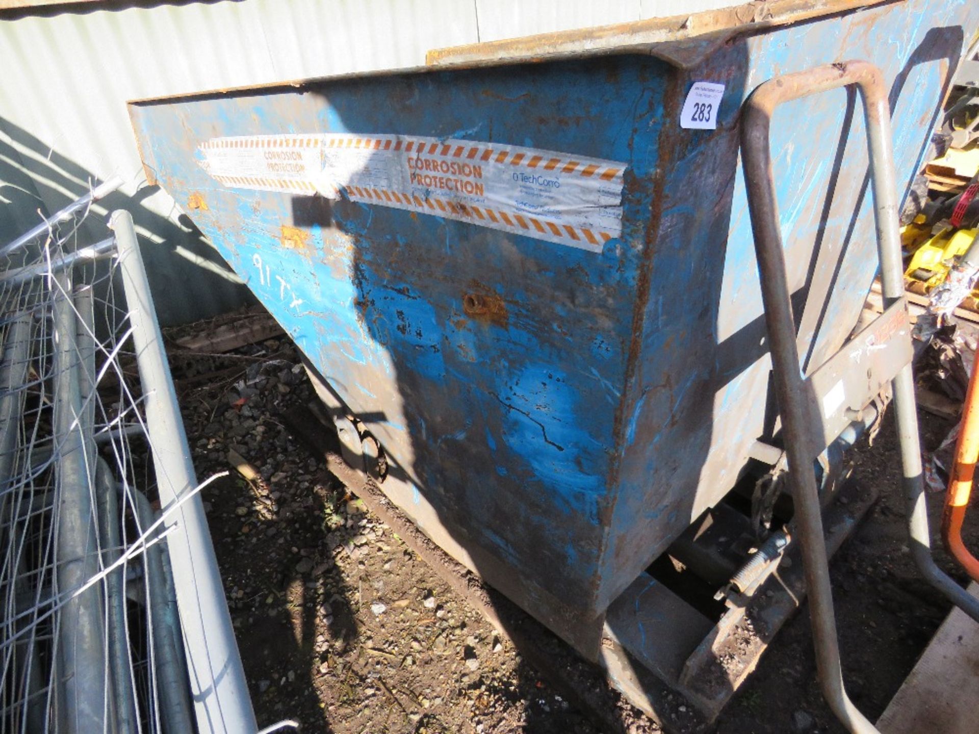 BLUE TIPPING FORKLIFT SKIP.