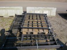 STACK OF ASSORTED METAL GATES. INCLUDING BOW TOPPED DRIVEWAY GATES.