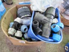 BOX OF LARGE PLASTIC PIPE CONNECTORS AND FITTINGS.