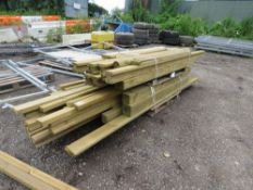 STACK OF ASSORTED TIMBER FENCING POSTS AND TIMBERS.