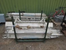 STILLAGE CONTAINING ASSORTED SCAFFOLD TOWER POLES AND PARTS.