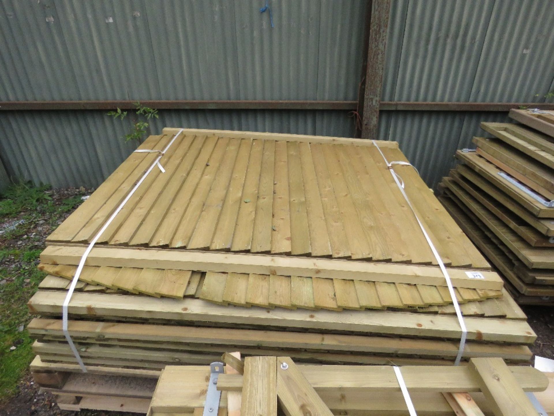 STACK OF 13NO ASSORTED WOODEN FENCING PANELS.