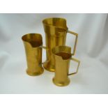 Set of brass measuring jugs