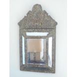 Brass repousse cushion mirror