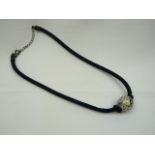 Black cord necklace with ceramic bead