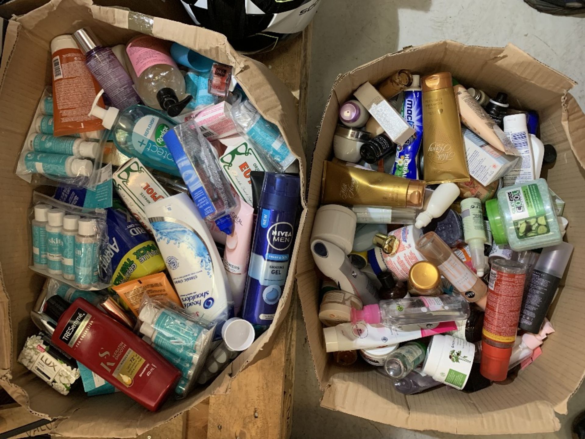 Two boxes part used toiletries and cosmetics.
