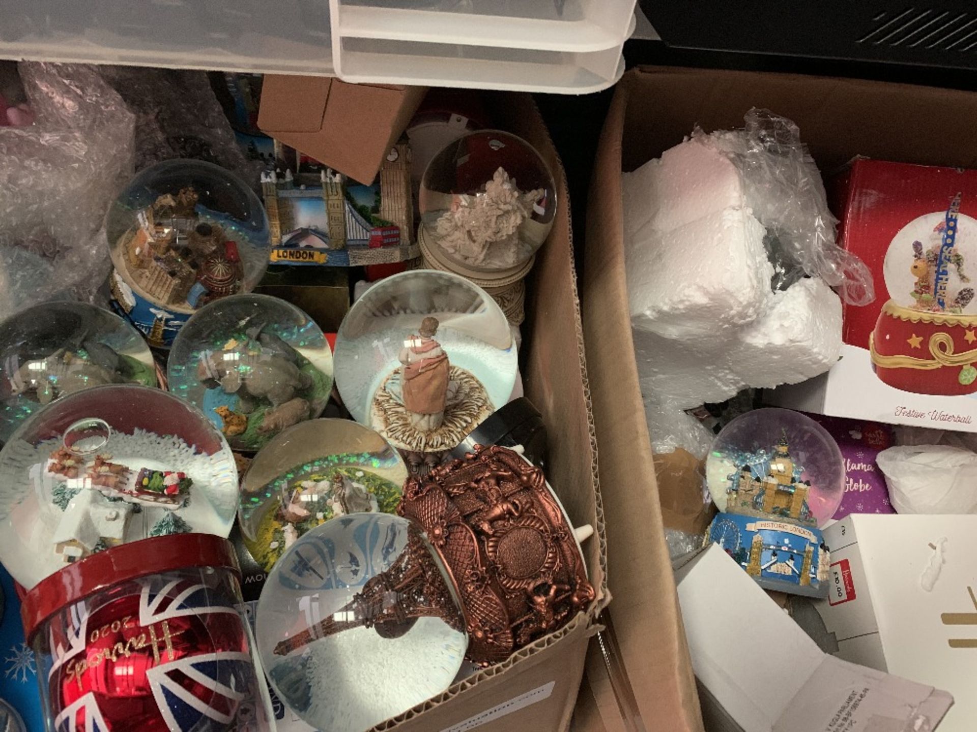 Snow globes in two boxes approximately Forty units.