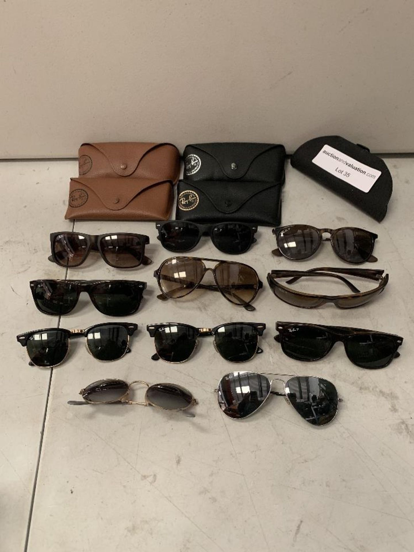 Ray-Ban branded sunglasses Eleven pairs and Five cases.