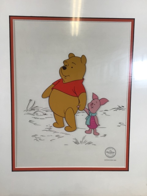 A framed plexiglass of Winnie the Pooh holding hands with Piglet. Limited to 5,000.