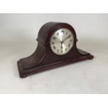 A eight day mahogany mantel clock. Movement made in Germany, stamped Kienzle.