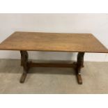 An oak coffee table with clover relief detail.W:102cm x D:49cm x H:50cm