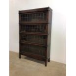 An oak four section Globe Wernike bookcase with leaded glass. With Globe Wernike badge in top