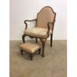 An upholstered carver bedroom chair with footstool.