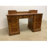 A late 19th early 20th century Heal and Son satin birch twin pedestal desk. Stamped Heal and Son