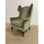 A Victorian Queen Anne style wing back arm chair on castors.W:82cm x D:72cm x H:112cm