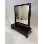 A mahogany dressing table mirror with three drawers. W:57cm x D:22cm x H:64cm