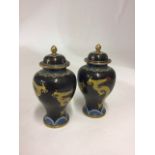A pair of 20th century baluster shaped lidded cloissone vases with dragon decoration.  H:19cm