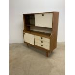 A Schrieber mid century kitchen sideboard with drop down door along side sliding glass doors.