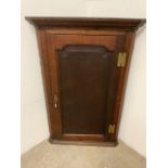 A Victorian oak corner cupboard, fitted with three internal shelves. W:70cm x D:40cm x H:106cm