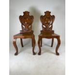 A pair of Victorian oak gothic revival hall chairs with lion pad feet. W:44.5cm x D:39cm x H:98cm