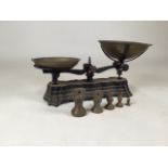 Cast iron weighing scales with five weights. 1/4 oz to 8oz