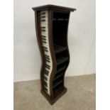A Quirky decorative cd stand in the form of a piano.W:23cm x D:30cm x H:98cm