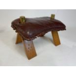 A Leather camel stool foot rest with brass camel details and stud work to legs.W:60cm x D:40cm x