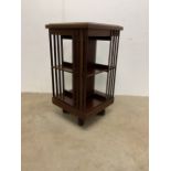 A revolving bookcase on wooden base.W:48cm x D:48cm x H:88cm