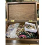 A collection of costume jewellery in a mahogany box.
