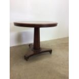 A circular pine table on octagonal pedestal to triangular platform and castors.W:87cm x D:87cm x