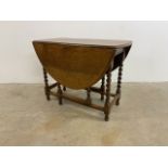 An oak gate leg table with barley twist legsW:105cm x D:48cm x H:76cm