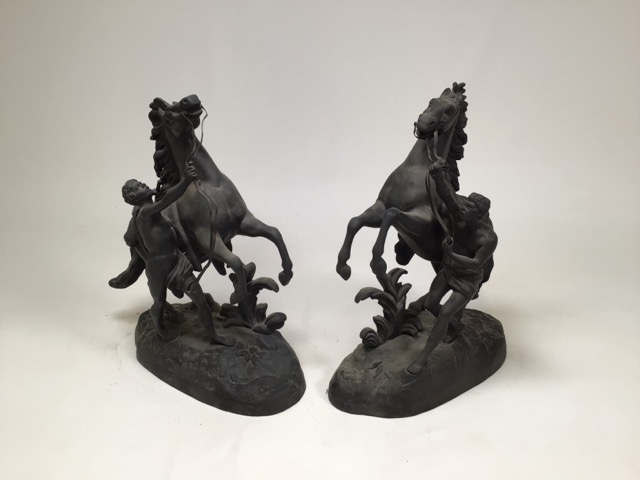 After Guillaume Costeau - Pair of bronze Marley horses with horsemen, each in rearing pose on oval