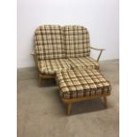 A Ercol style two seater beech framed sofa with a Ercol stamped matching foot stall