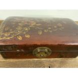 A Japanese leather painted jewellery box.W:29cm x D:17cm x H:11cm