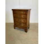 A small mahogany chest, with four drawers, pull out bars and a fold over top to form a table.W: