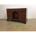 A Georgian inlaid kneehole desk with central door to interior cupboard with three drawers either