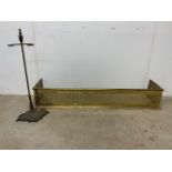 A brass fender also with a brass stick stand.W:124cm x D:30cm x H:20cm
