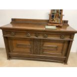 A solid oak sideboard with brass handles also with a mirror and an etching.W:78cm x D:60cm x H: