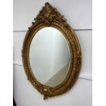 A large oval gilt mirror with bevelled edge.W:105cm x H:152cm