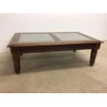 A stained pine coffee table with two rattan inserts and glass toppedW:128cm x D:68cm x H:43cm