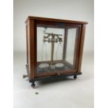 A Griffin & Tadlock LTD chemist scales in mahogany glass case