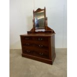 A stained pine dressing chest with four lower drawers bevelled mirror and vanity drawers to top