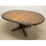 An Ercol style elm extending dining table