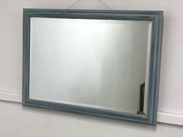 A blue painted bevelled edged mirror.W:82cm x D:cm x H:58cm