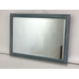 A blue painted bevelled edged mirror.W:82cm x D:cm x H:58cm