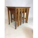 A 1960s nest of tables by Poul Hundevad, rectangular table on castors with four drop leaf nesting