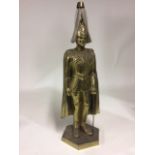 A large gilt brass fireside poker stand model of a Grenadier Guard on hexagonal plinth base. Reg