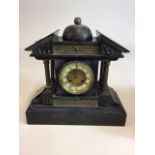 J. Unghans - a German slate and gilt brass mantle clock of architectural form with roof like