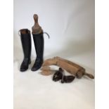 A pair of knee high leather boots, size 5 1/2. Together with three different sized shoe trees.